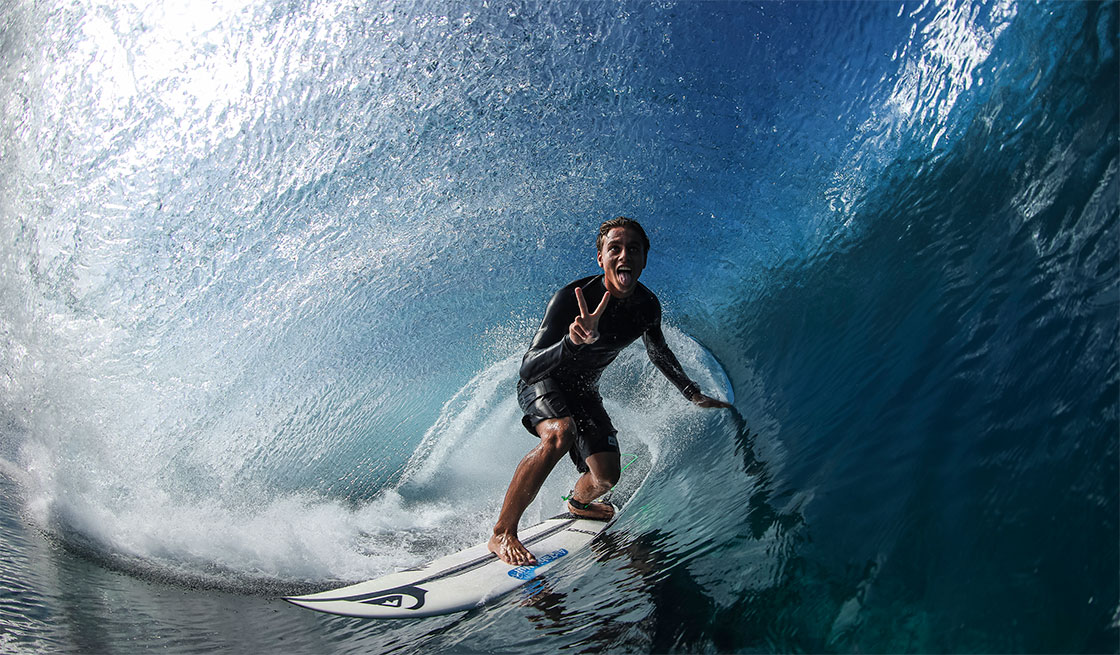 Surfer riding waves